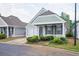 Well-maintained home featuring a green exterior and manicured landscaping at 134 Rose Cottage Ln, Woodstock, GA 30189