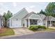 Exterior elevation of a well-maintained, light green house with nice landscaping at 134 Rose Cottage Ln, Woodstock, GA 30189