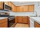Bright kitchen features wood cabinets, white countertops, stainless steel appliances, and modern faucet at 134 Rose Cottage Ln, Woodstock, GA 30189