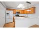 Bright kitchen features wood cabinets, white countertops, stainless steel appliances, and skylight at 134 Rose Cottage Ln, Woodstock, GA 30189
