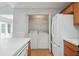 Laundry area with appliances tucked away between kitchen and sliding glass door to patio at 134 Rose Cottage Ln, Woodstock, GA 30189