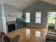 Living room boasts hardwood floors, vaulted ceiling, fireplace, and abundant natural light at 134 Rose Cottage Ln, Woodstock, GA 30189