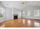 Bright living room featuring hardwood floors, fireplace, vaulted ceiling, and natural light from large windows at 134 Rose Cottage Ln, Woodstock, GA 30189