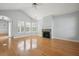 Bright living room featuring hardwood floors, fireplace, vaulted ceiling, and natural light from large windows at 134 Rose Cottage Ln, Woodstock, GA 30189