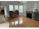 Inviting living room features hardwood floors, a fireplace, and multiple windows for ample sunlight at 134 Rose Cottage Ln, Woodstock, GA 30189