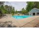 Community pool surrounded by trees and a wooden fence offering a refreshing oasis for residents at 134 Rose Cottage Ln, Woodstock, GA 30189