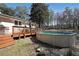 Backyard featuring an above-ground pool, a deck, and mature trees at 3948 Lake Carlton Road S Rd, Loganville, GA 30052