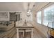 Dining area featuring a long table with seating for six, light fixture, and sliding barn door to the living room at 3948 Lake Carlton Road S Rd, Loganville, GA 30052