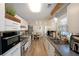 Galley kitchen with stainless steel appliances, white cabinets, and wood-look flooring, providing a modern, clean aesthetic at 3948 Lake Carlton Road S Rd, Loganville, GA 30052