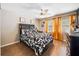 Comfortable bedroom featuring a queen bed, wood floors, ceiling fan and bright window at 4648 Danna Dr, Austell, GA 30106