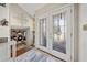 Inviting entryway showcasing glass-paneled double doors leading to a living area with hardwood floors at 4648 Danna Dr, Austell, GA 30106