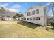 A two-story white brick and siding home with a large lawn and outbuilding at 4648 Danna Dr, Austell, GA 30106