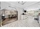 Open-concept kitchen and dining area with white cabinets, stainless steel appliances, and modern lighting at 4648 Danna Dr, Austell, GA 30106