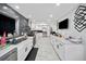 Modern kitchen featuring white cabinetry, sleek black hardware, stainless appliances, and a stylish subway tile backsplash at 4648 Danna Dr, Austell, GA 30106