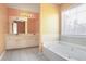 Well-lit bathroom with double vanity, soaker tub, and large window at 494 Martin Forest Ln, Lawrenceville, GA 30045