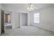 Bright bedroom featuring ceiling fan, closet, and neutral color scheme at 494 Martin Forest Ln, Lawrenceville, GA 30045