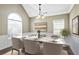 Staged dining room with marble table, seating for six and lots of natural light at 494 Martin Forest Ln, Lawrenceville, GA 30045