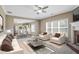 Open-concept living room with fireplace, lots of natural light and a view into the kitchen at 494 Martin Forest Ln, Lawrenceville, GA 30045