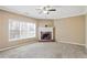 Cozy living room with fireplace, ceiling fan, and neutral carpet at 494 Martin Forest Ln, Lawrenceville, GA 30045