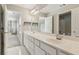 Bathroom with double sink vanity, white cabinets, and large mirror at 7270 Sheffield Pl, Cumming, GA 30040