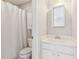 Well-lit bathroom with a shower and white vanity with a medicine cabinet at 7270 Sheffield Pl, Cumming, GA 30040