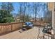 Relaxing outdoor deck space with stylish wicker furniture and a view of the lush backyard at 7270 Sheffield Pl, Cumming, GA 30040