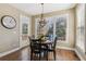 Cozy dining area features a chandelier and a view of the backyard deck at 7270 Sheffield Pl, Cumming, GA 30040