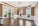 Elegant dining room with hardwood floors, chandelier, and wainscoting details at 7270 Sheffield Pl, Cumming, GA 30040