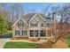 Charming two-story home with a well-manicured lawn, covered porch, and blue shutters at 7270 Sheffield Pl, Cumming, GA 30040