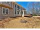 Beautiful home exterior showcasing large windows, deck area, and cozy fire pit for outdoor enjoyment at 7270 Sheffield Pl, Cumming, GA 30040