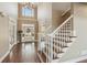 Grand foyer with a staircase, chandelier, and views into the main living area at 7270 Sheffield Pl, Cumming, GA 30040