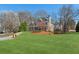 Expansive front yard with a mature tree and a view of the home's facade at 7270 Sheffield Pl, Cumming, GA 30040