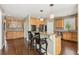 Kitchen with wooden cabinets, stainless steel appliances, and breakfast bar seating at 7270 Sheffield Pl, Cumming, GA 30040