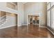 Open-concept living room with hardwood floors and an open staircase at 7270 Sheffield Pl, Cumming, GA 30040