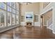 Bright living room with a fireplace, built-in shelving, and large windows at 7270 Sheffield Pl, Cumming, GA 30040