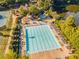 Aerial view of community pool featuring lounge chairs and clear blue water for summer relaxation at 7270 Sheffield Pl, Cumming, GA 30040