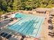 Large community pool with several lounge chairs for relaxing in the sun or under a shaded umbrella at 7270 Sheffield Pl, Cumming, GA 30040