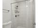 Updated bathroom with a tiled shower featuring a rainfall showerhead and convenient shelving at 101 Natchez Trce, Atlanta, GA 30350