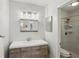 Bright bathroom with modern vanity, stylish mirror, and updated tiled shower at 101 Natchez Trce, Atlanta, GA 30350