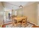 Formal dining room with a wood table, chairs, mirrored wall, modern light fixture, and view to living area at 101 Natchez Trce, Atlanta, GA 30350