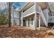 Charming exterior elevation of a two-story home with gray siding, a front door, and an exterior staircase at 101 Natchez Trce, Atlanta, GA 30350