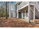 Inviting exterior elevation of a two-story home with gray siding, a front door and an exterior staircase at 101 Natchez Trce, Atlanta, GA 30350