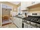 Cozy kitchen with white cabinets, stainless steel appliances and view into a dining room at 101 Natchez Trce, Atlanta, GA 30350