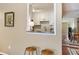 View into kitchen with white cabinets, tile backsplash, granite countertops and stainless sink at 101 Natchez Trce, Atlanta, GA 30350