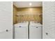 The laundry closet features a white washer and dryer and wire rack shelving at 101 Natchez Trce, Atlanta, GA 30350