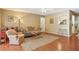 Cozy living room with hardwood floors, neutral walls, comfortable seating, and view into kitchen at 101 Natchez Trce, Atlanta, GA 30350