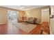 Bright living room with hardwood floors, neutral walls, comfortable seating, and view into sunroom at 101 Natchez Trce, Atlanta, GA 30350