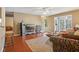 Inviting living room with hardwood floors, neutral walls, comfortable seating, and view into sunroom at 101 Natchez Trce, Atlanta, GA 30350