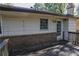 Exterior view of back deck with brick and siding home, door, and natural sunlight at 4042 Shady Nw Cir, Lilburn, GA 30047