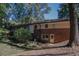 Home exterior from backyard featuring a brick foundation, back door, and porch at 4042 Shady Nw Cir, Lilburn, GA 30047